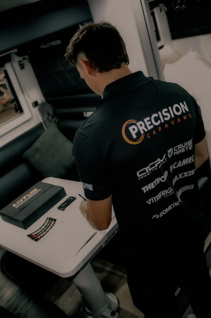 Precision Caravans technician performing professional mobile caravan service inside a caravan